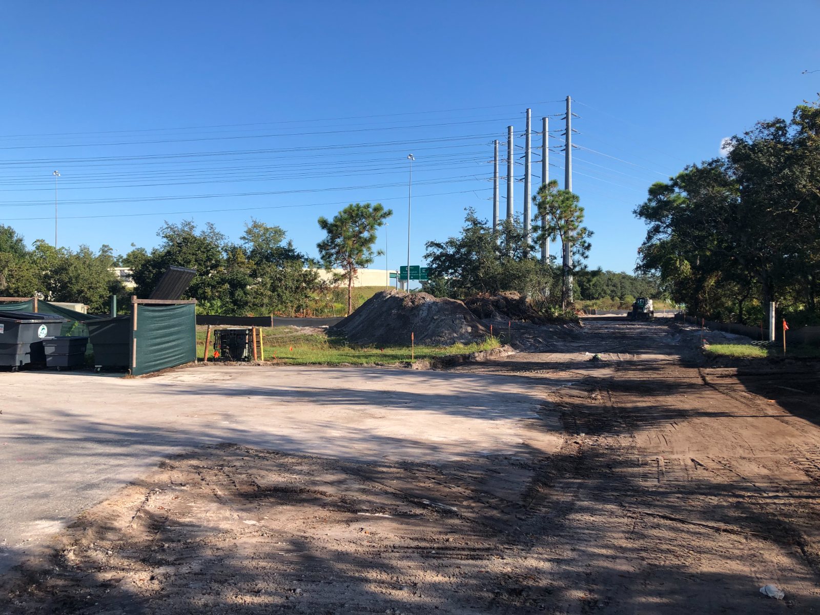 Graded and cleared commercial pad with the tree line beyond