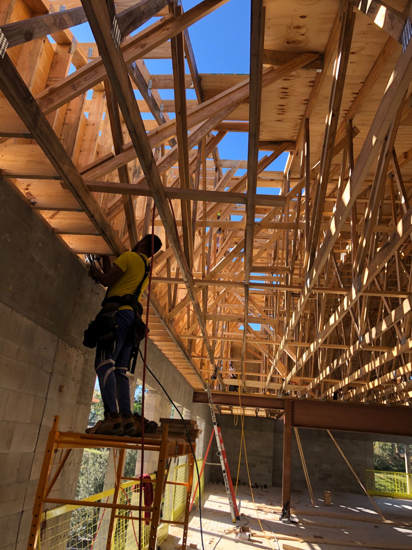 Liberty crew setting roof trusses over the classroom block
