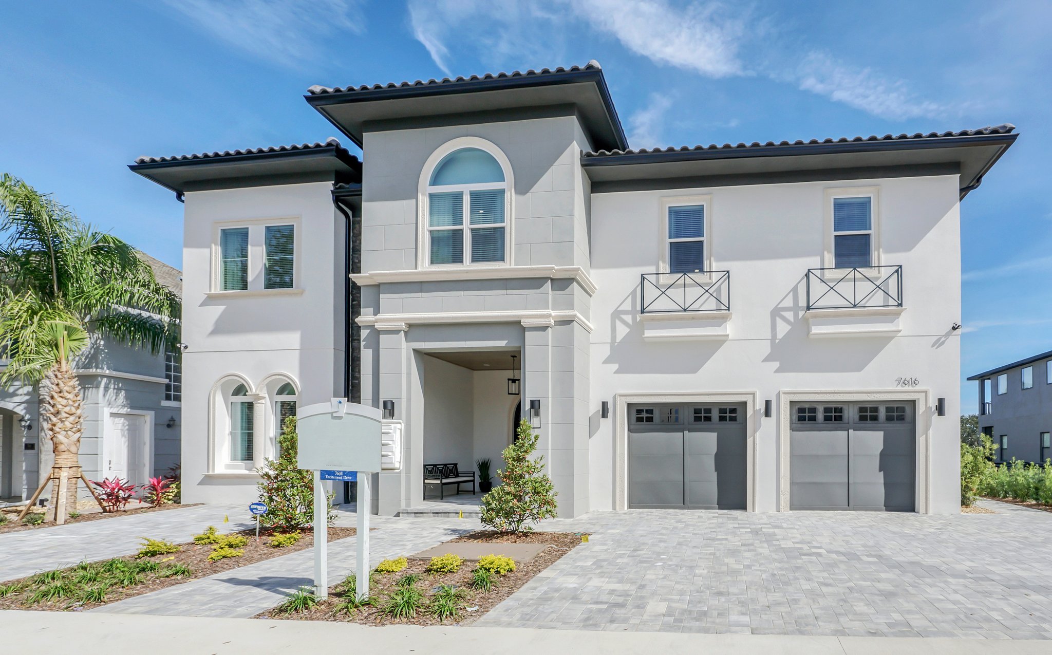 Excitement Drive — white-and-stone elevation by day