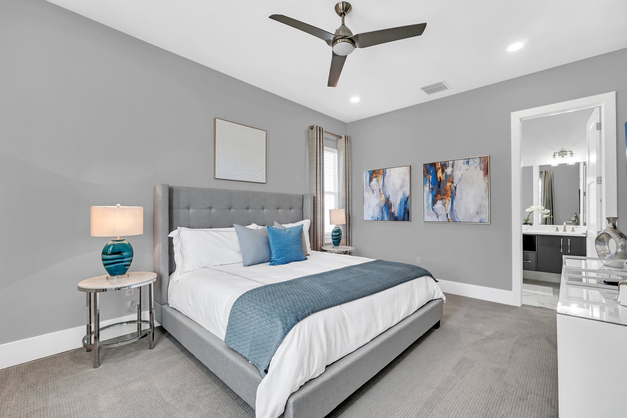 Guest bedroom with a teal accent wall and a king bed