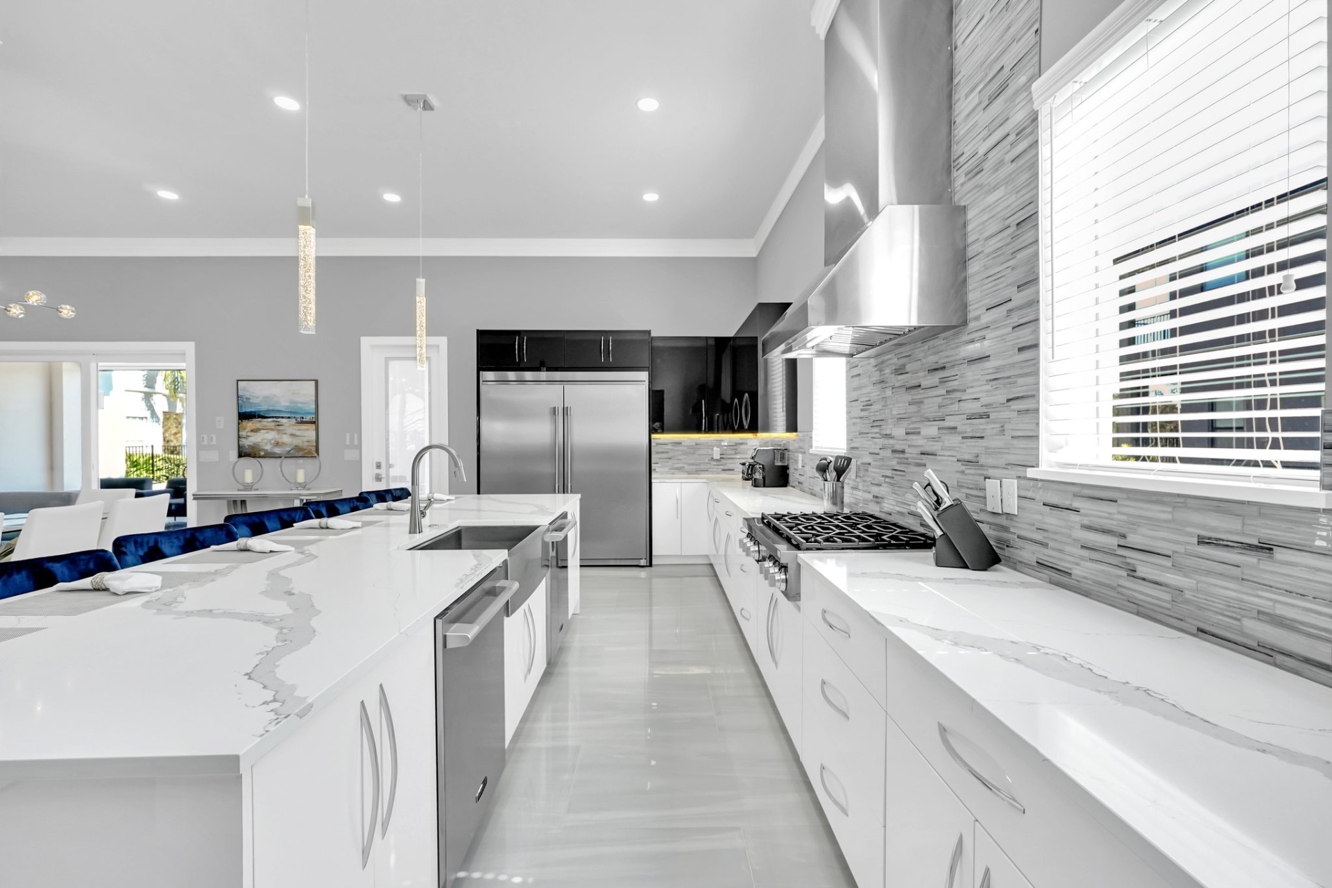 Chef's kitchen with a marble waterfall island and bar seating