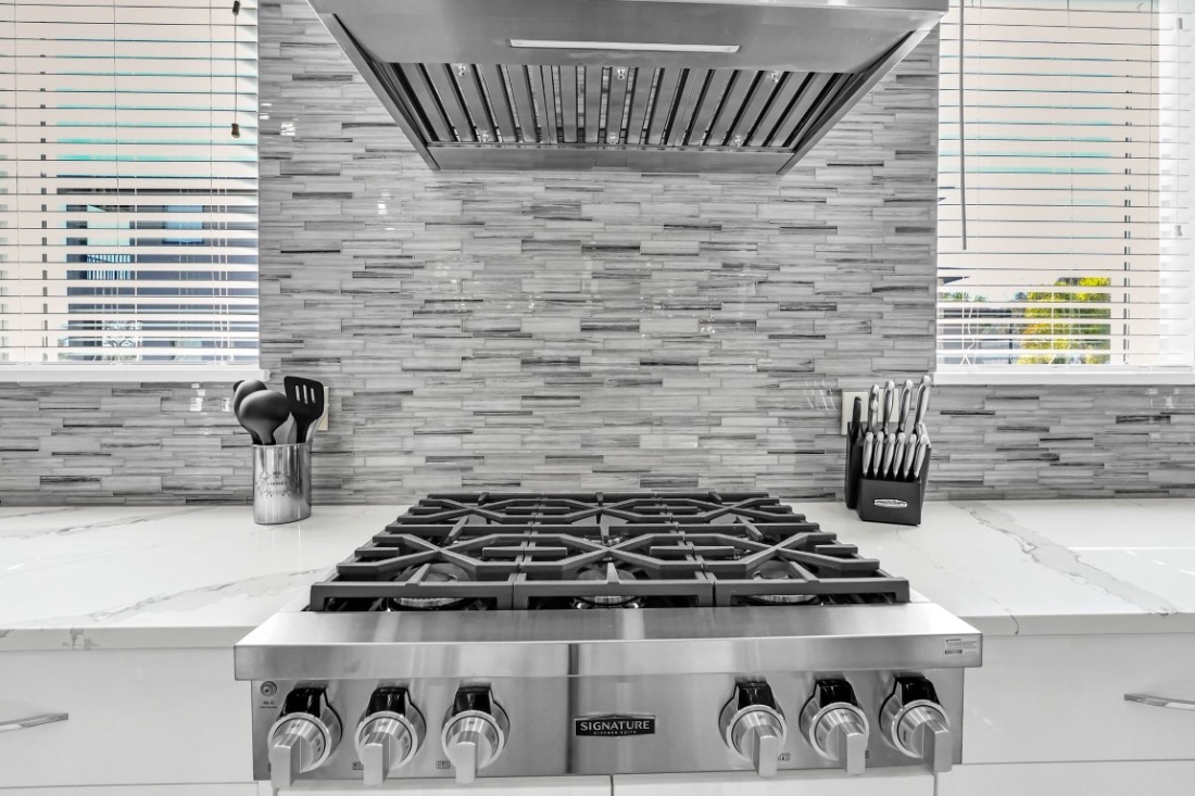 Commercial gas range with a marble slab backsplash