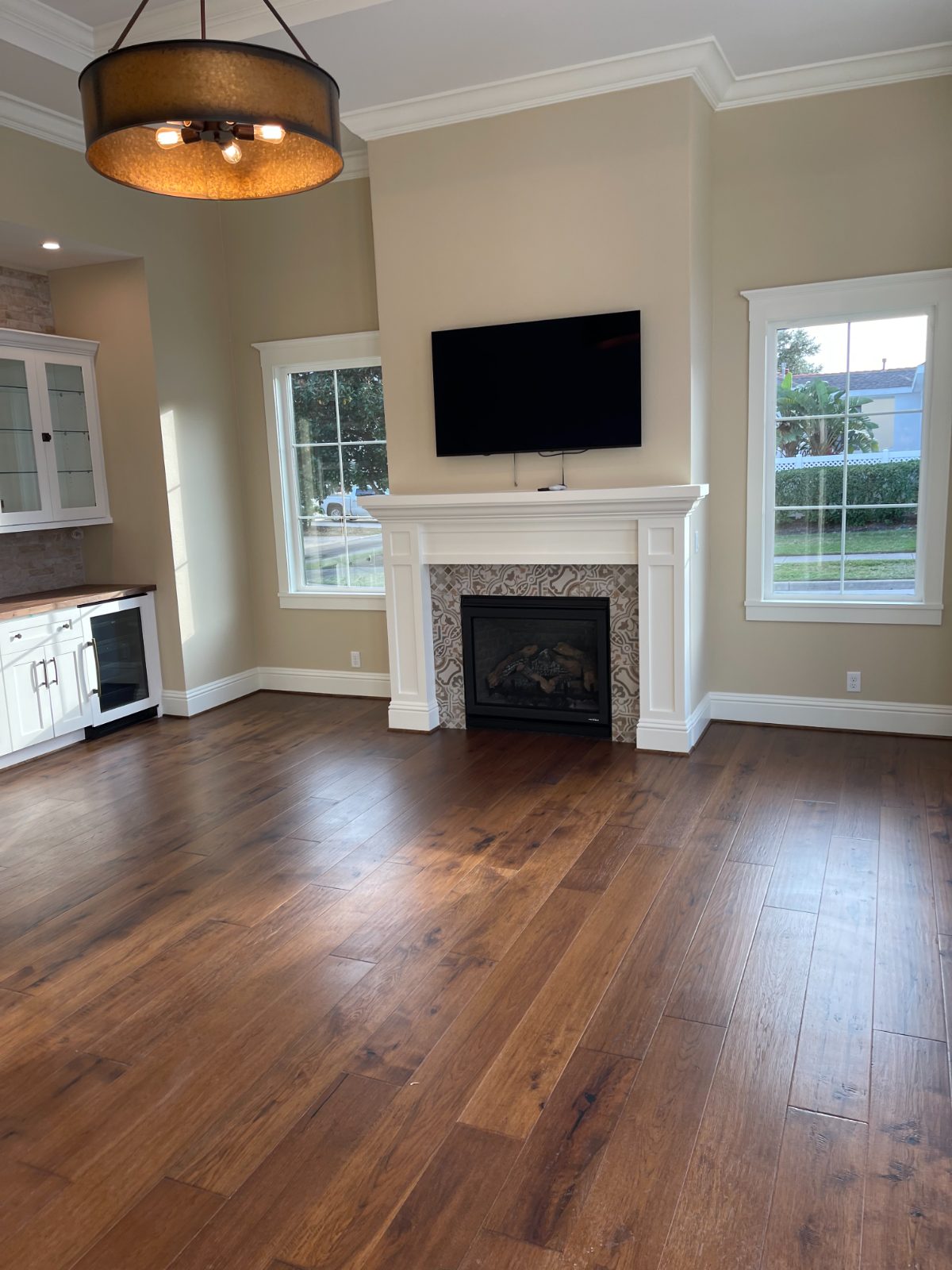 French Country — a family room with a painted mantel and a patterned-tile fireplace
