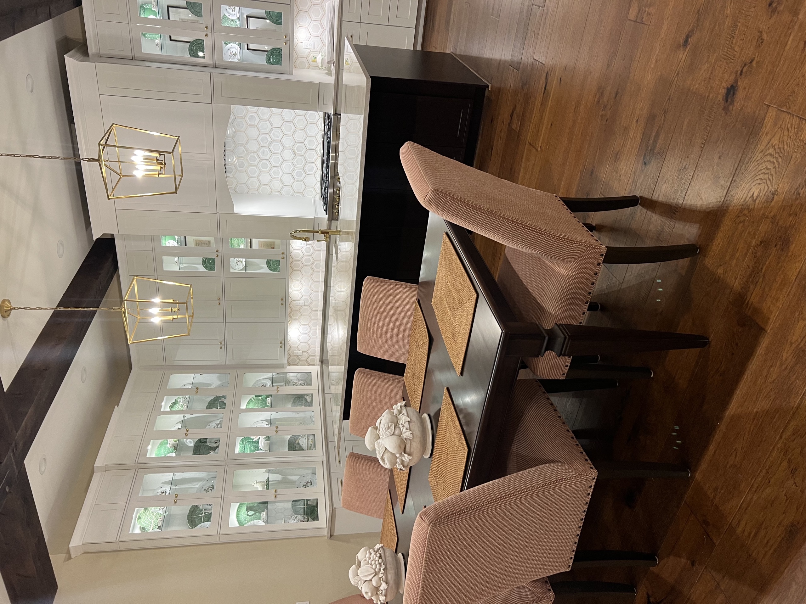 Kitchen island and dining table beneath lantern pendants