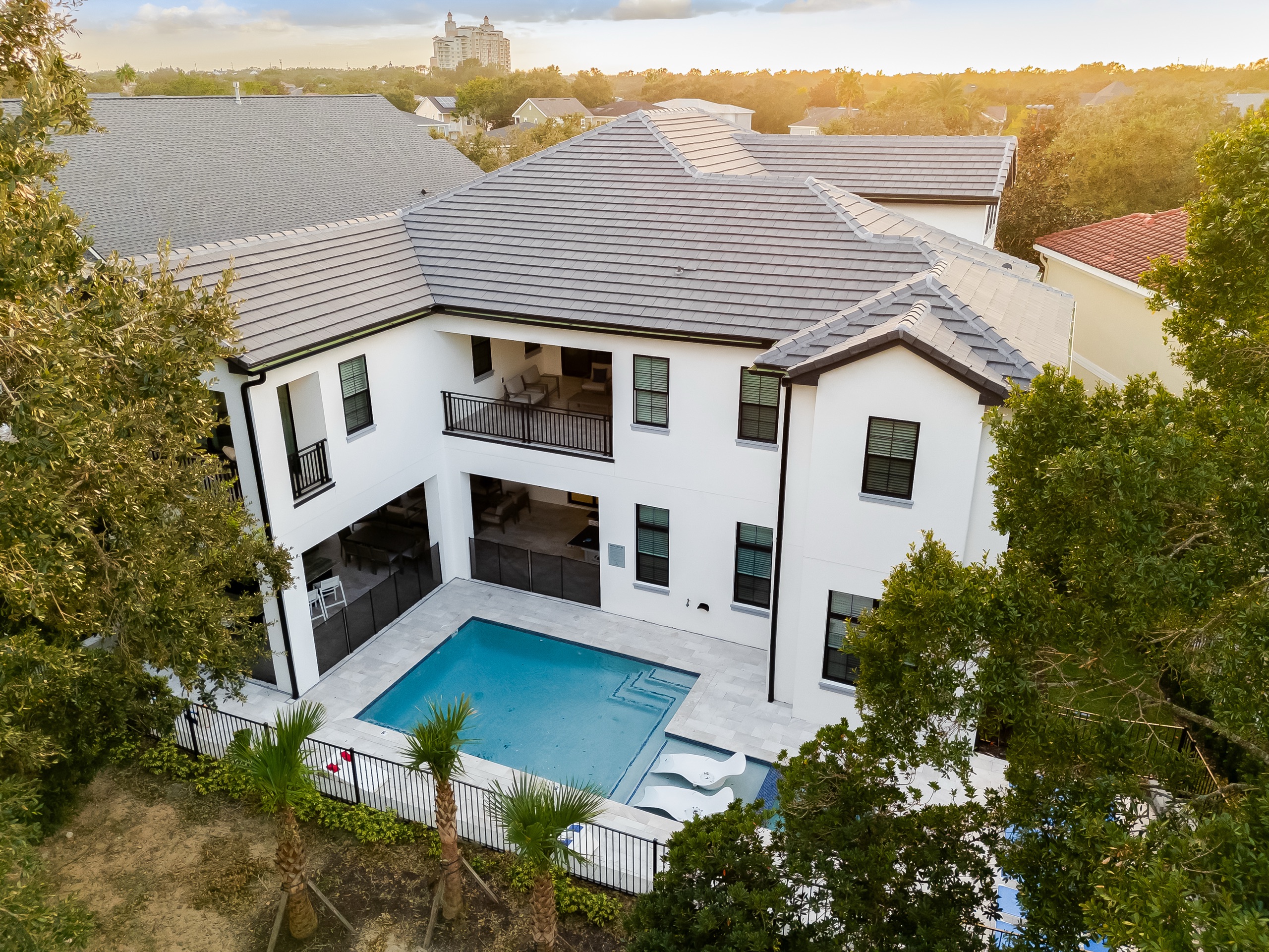 Aerial of the rear elevation and pool at sunset