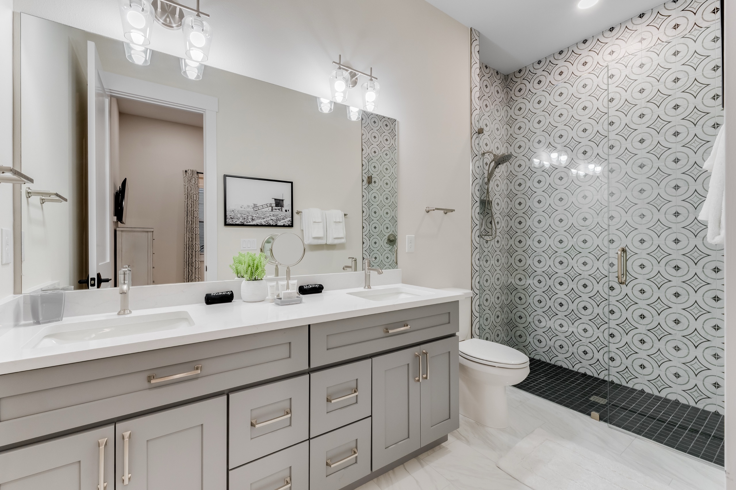 Guest bath with a black-and-white mosaic shower