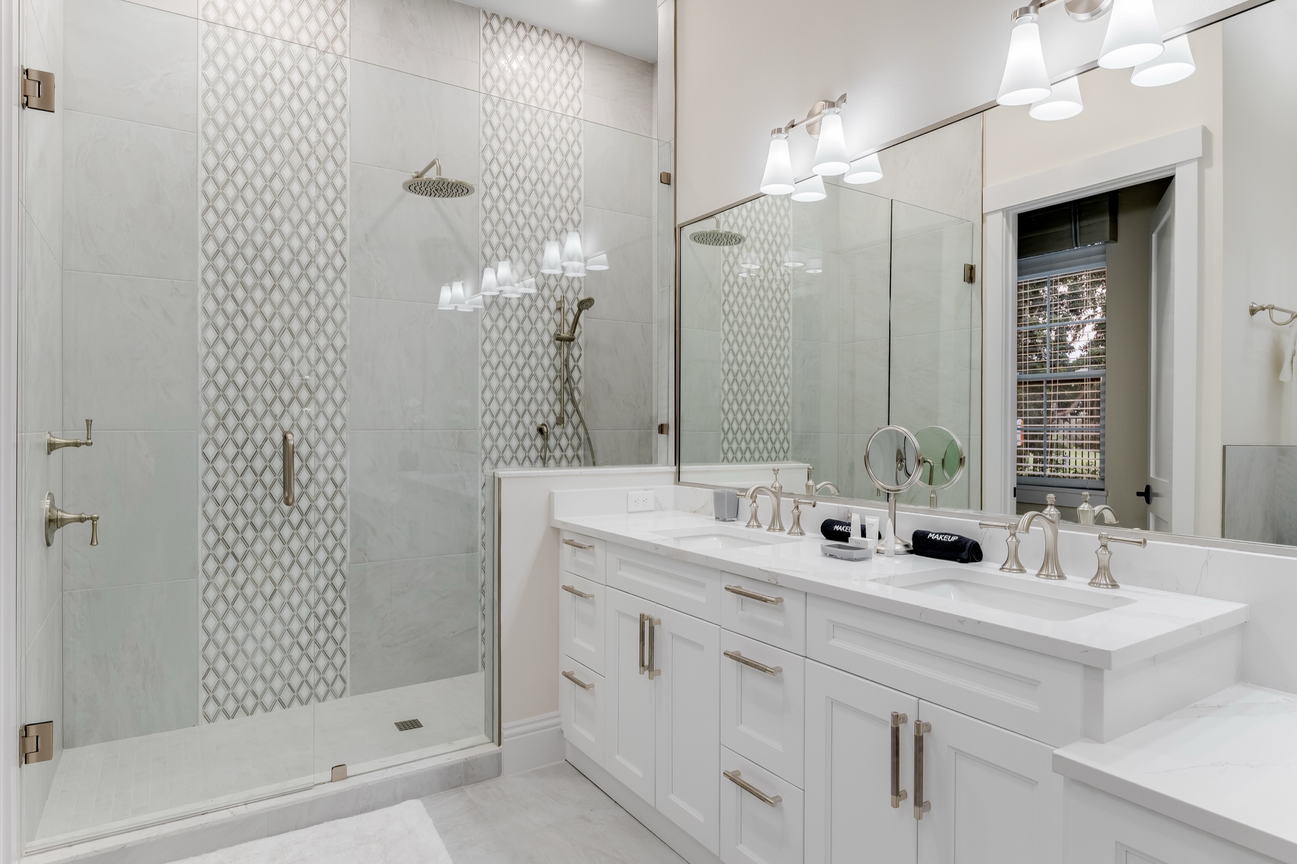 Guest bath with a dual vanity and detailed shower tilework