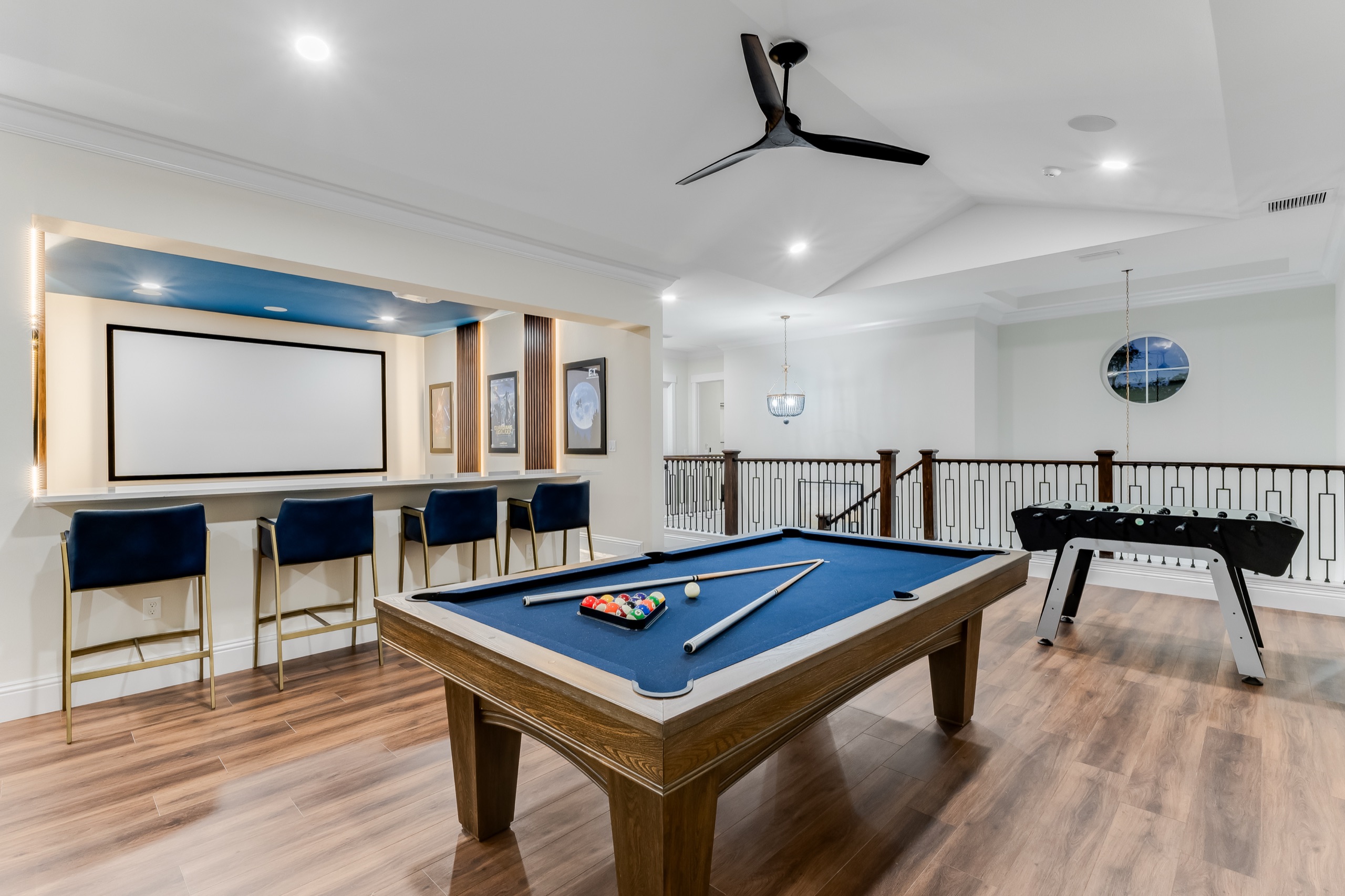 Billiards and a drop-down projector screen on the game floor