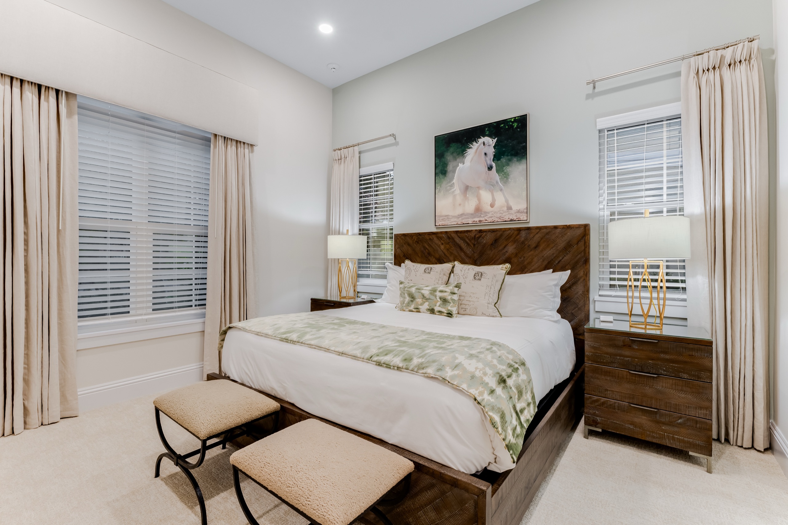 Downstairs en-suite bedroom with an upholstered bed and framed art