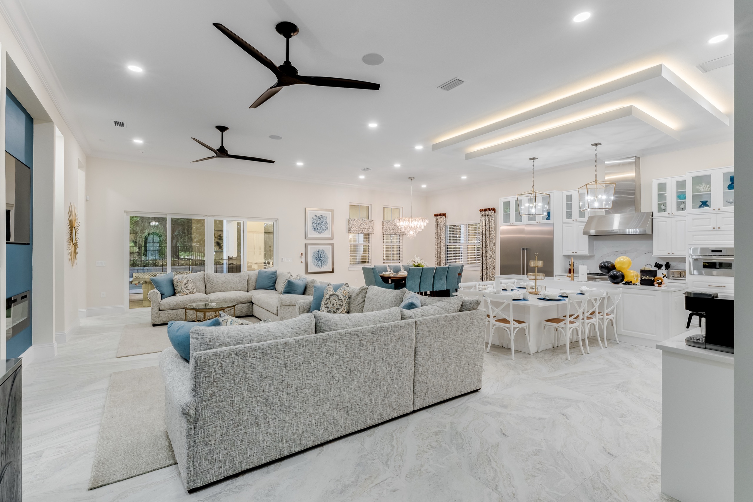 Great room open plan looking toward the dining area and windows