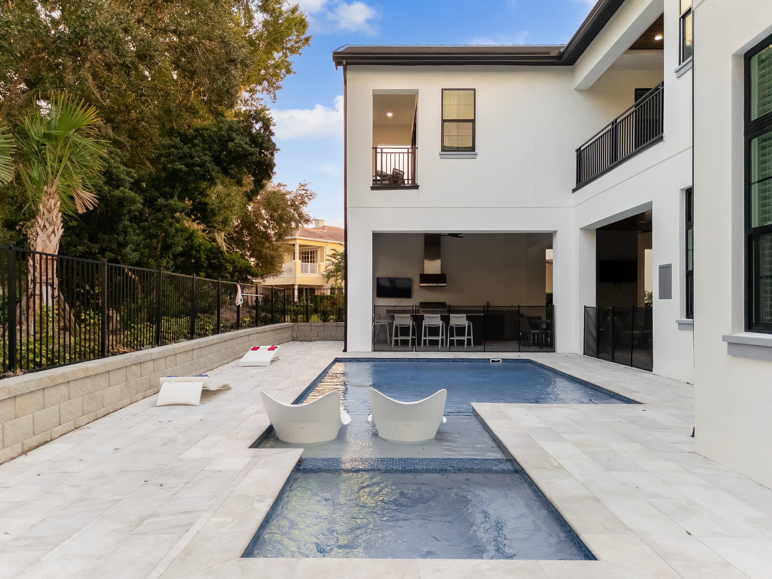 The pool and raised spa with in-water loungers