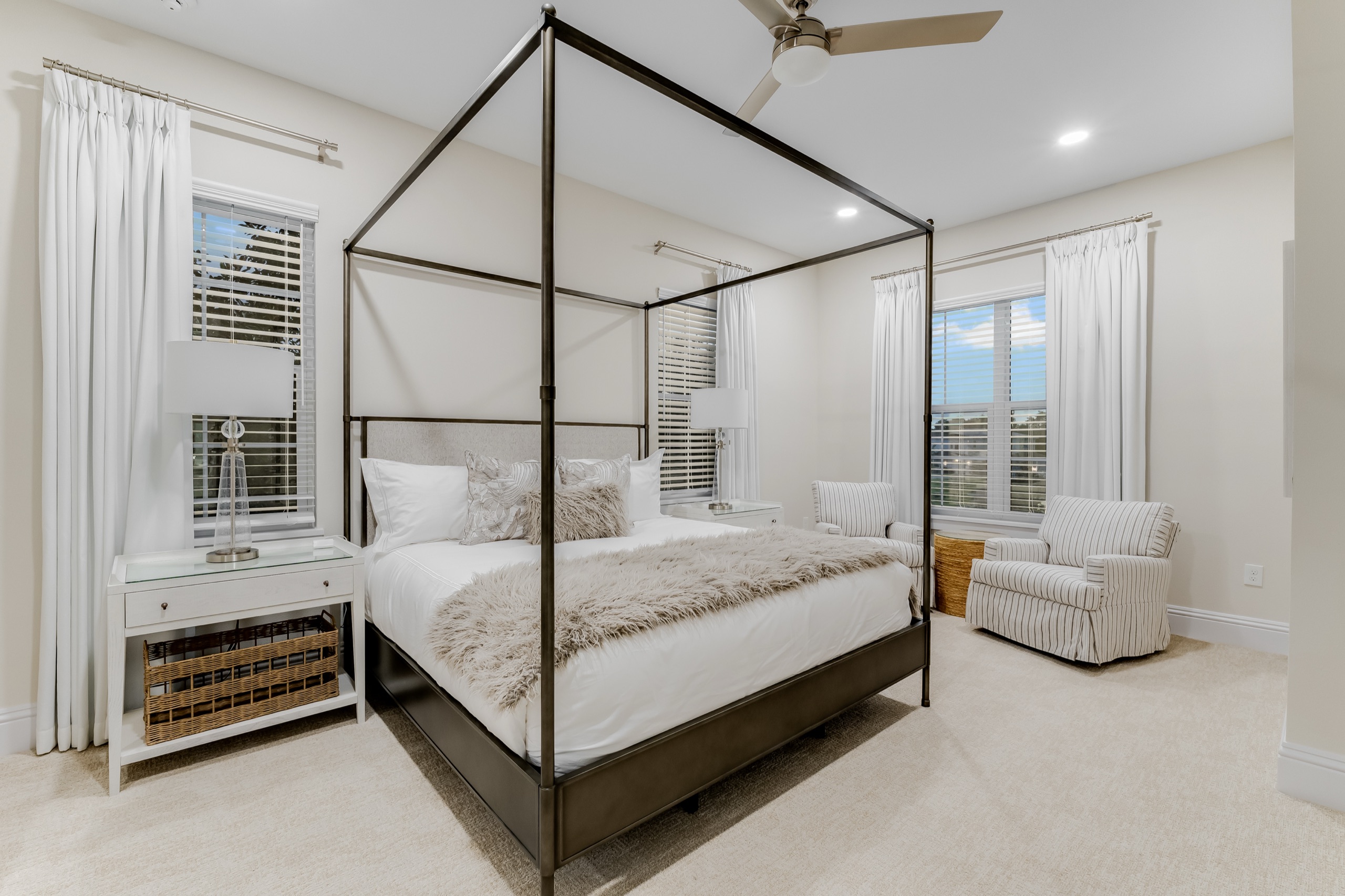 Guest suite with a black four-poster canopy bed