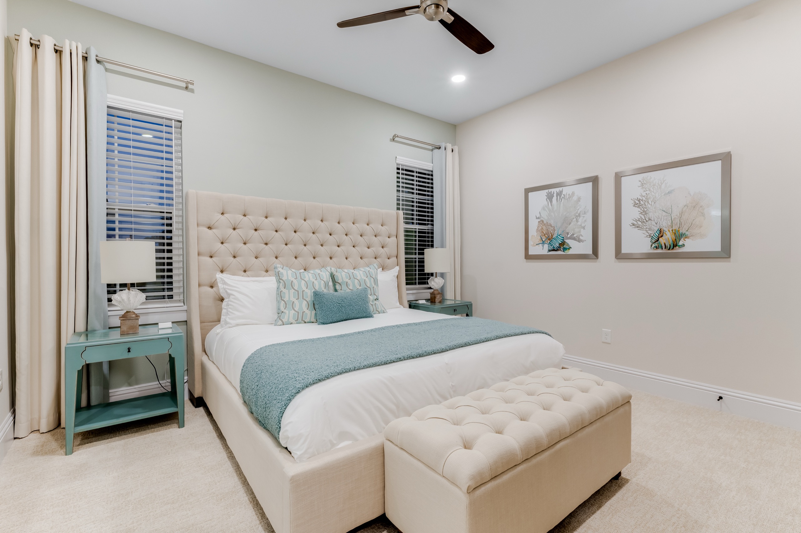 Guest suite with teal accents and an upholstered bed
