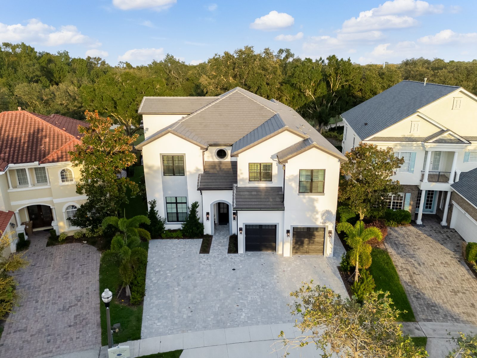 Gathering Loop — a golf-front custom residence at golden hour, seen from above