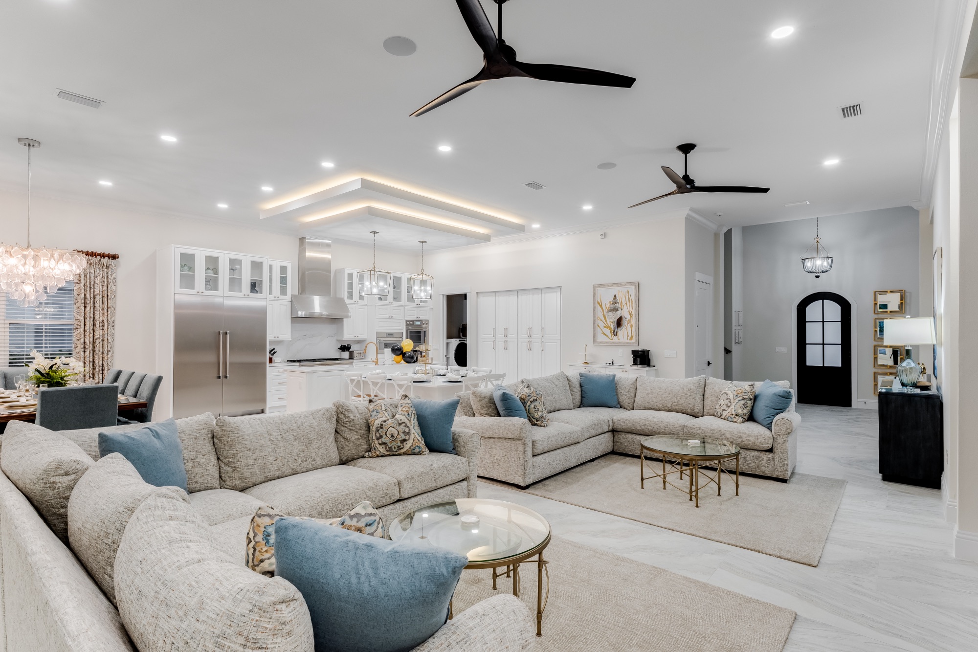 A bright, blue-and-white great room opening to the kitchen in a Liberty Partners residence