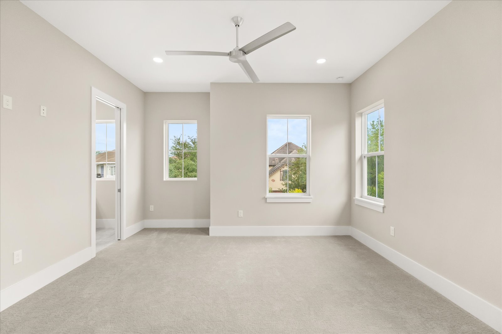 Carpeted bedroom suite with corner windows