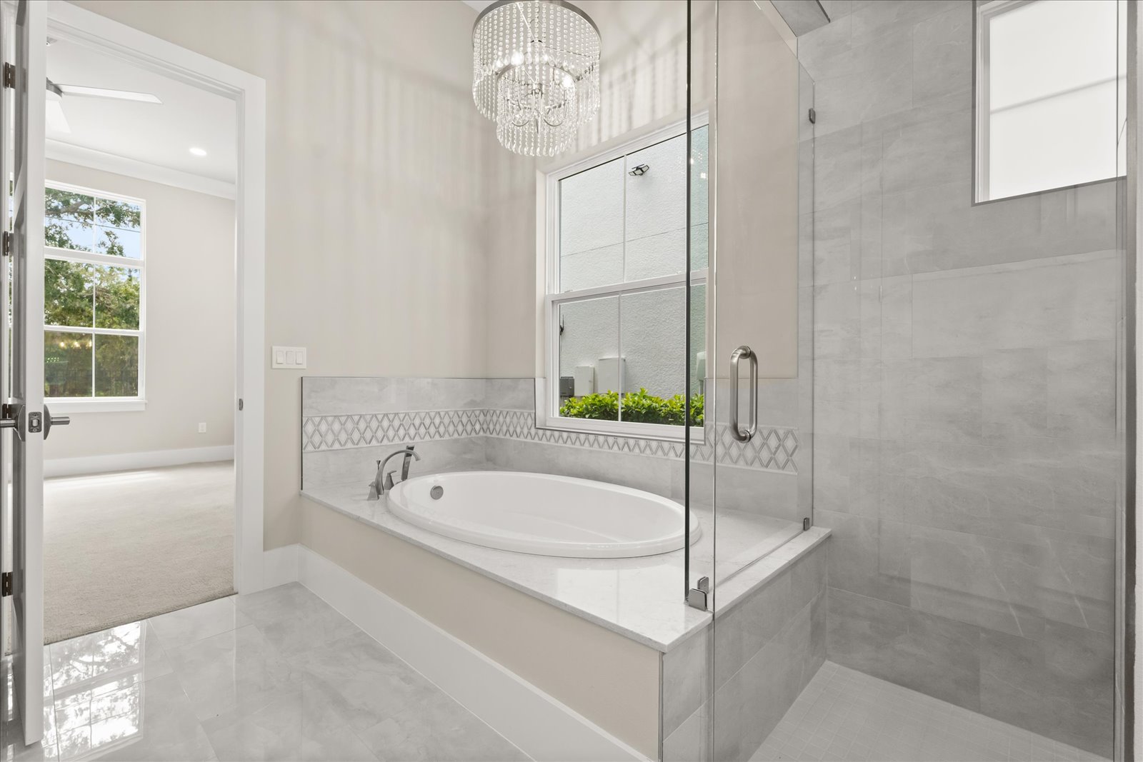 Primary bath with a soaking tub and a glass shower