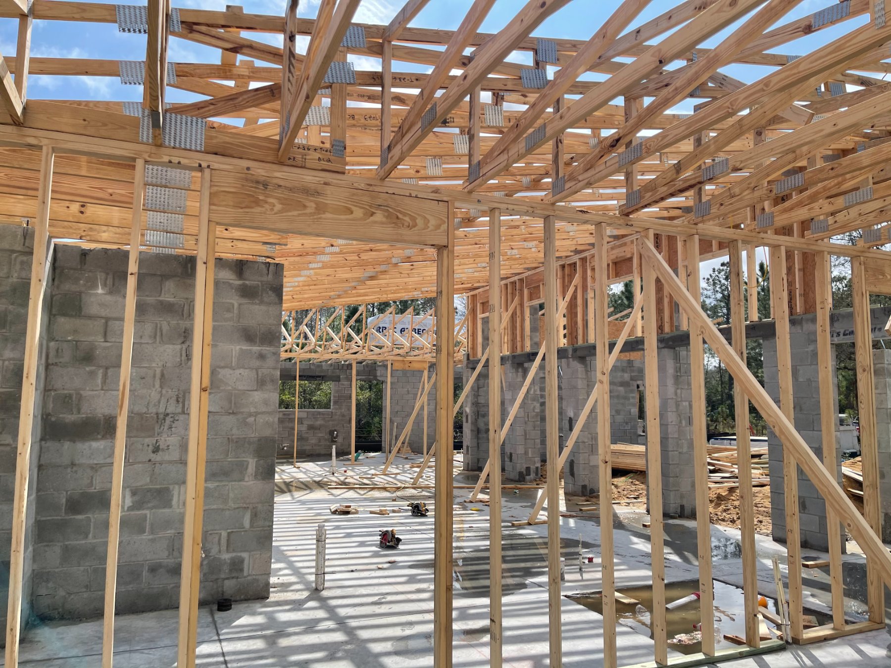Roof trusses and wall framing over the block shell on a Liberty build