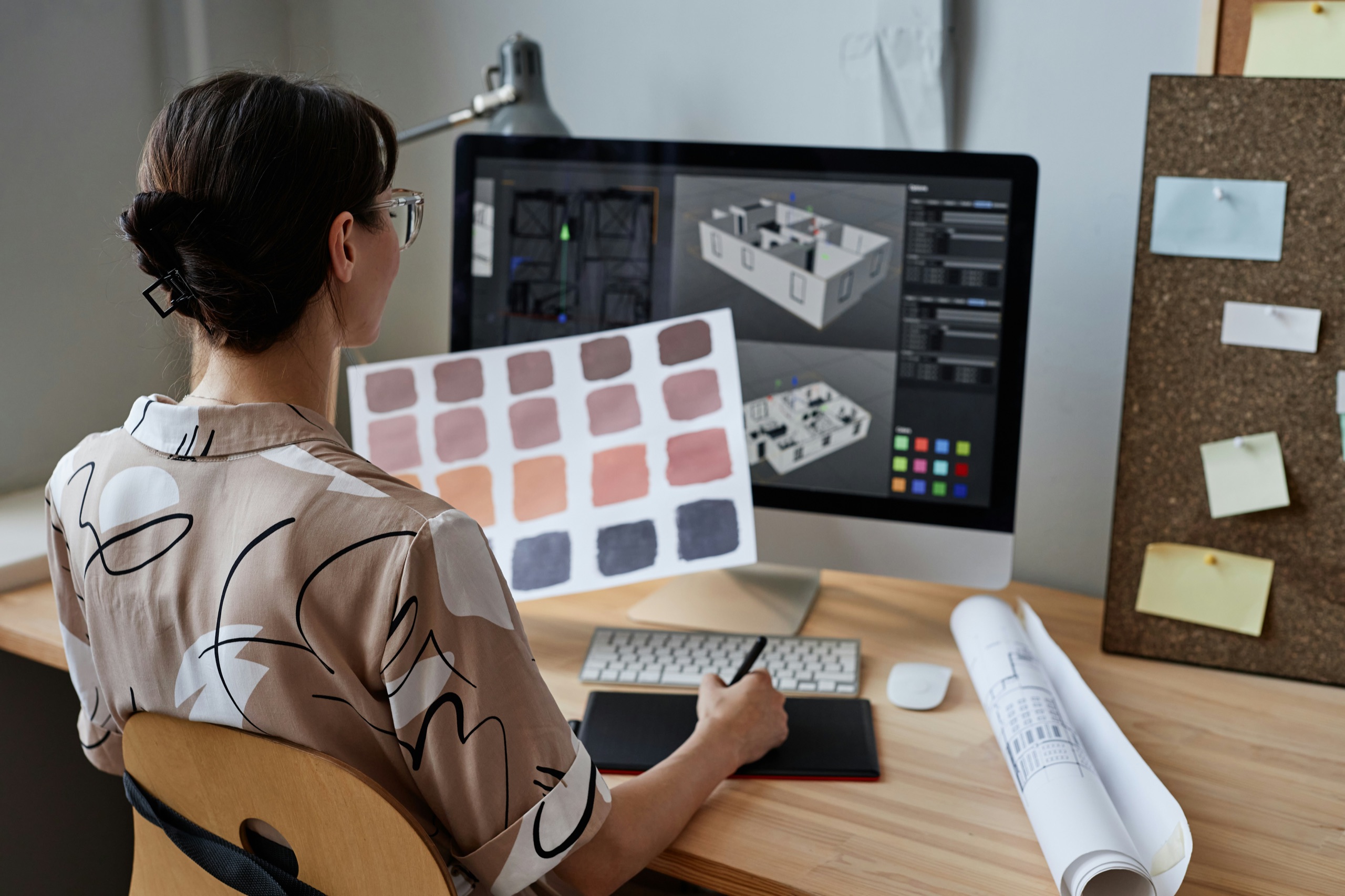 A 3D architectural model on screen with a material color palette
