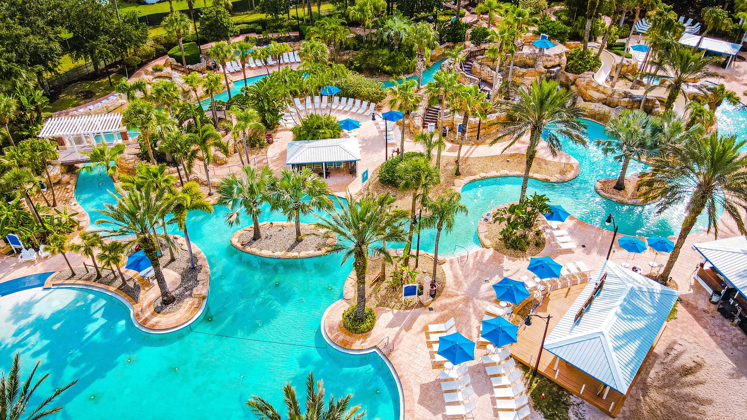 Reunion's multi-acre water park — the lazy river winding between palms and blue umbrellas