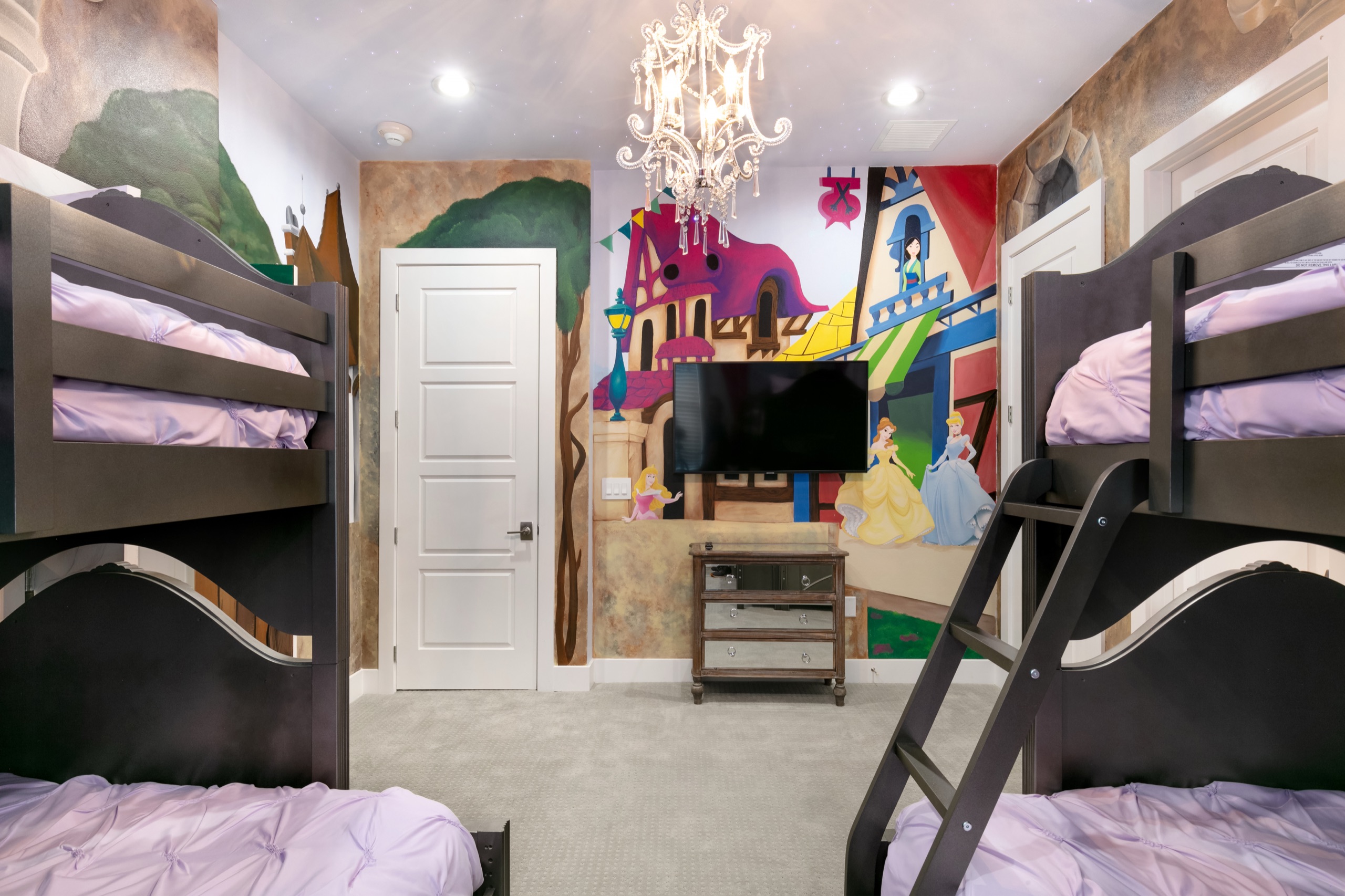 Storybook bunk room with a painted mural and twin bunks