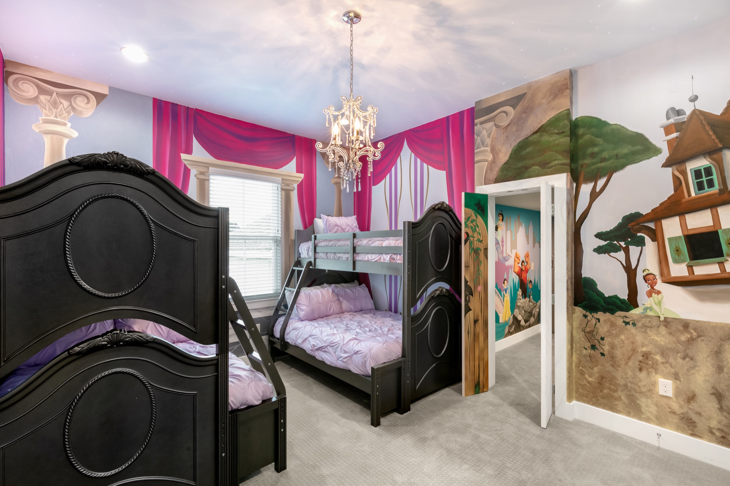 Princess-themed bunk room with a castle mural and ornate black bunks