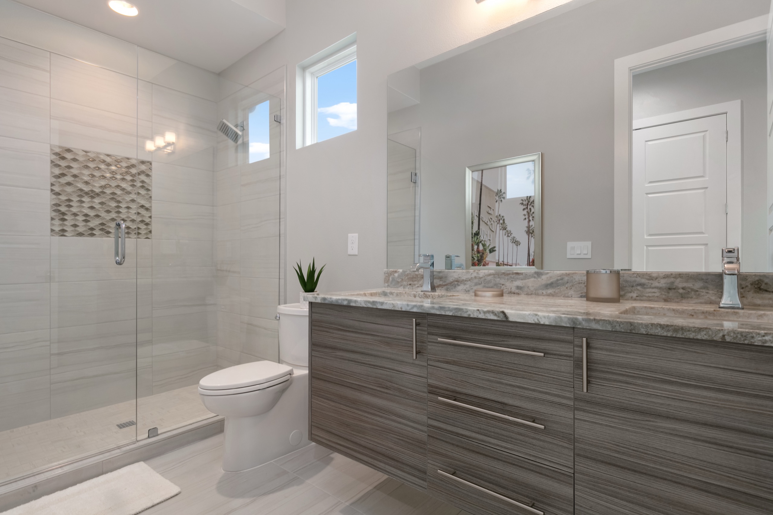 Guest bath with a frameless glass walk-in shower and a gray marble vanity