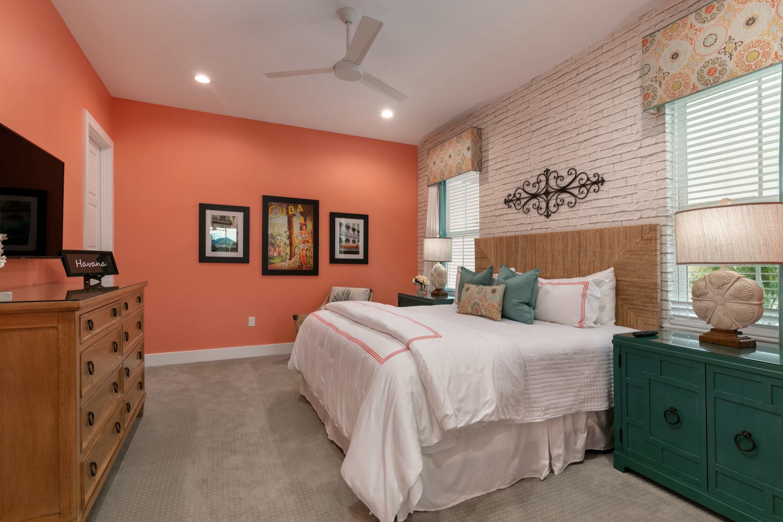 Coral-toned Havana guest suite with a brick accent wall and a woven headboard