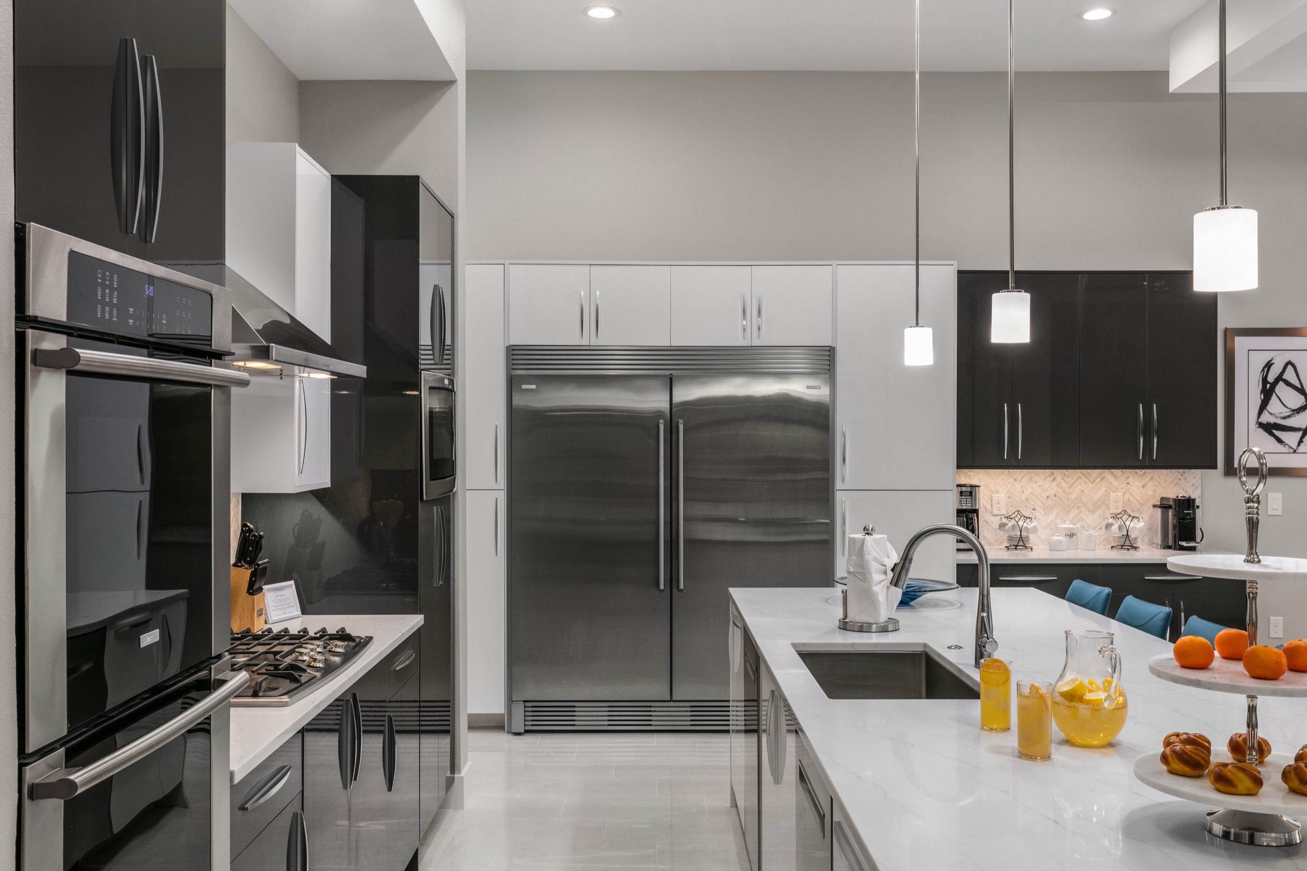 Kitchen detail with a pro range, double ovens, and marble counters