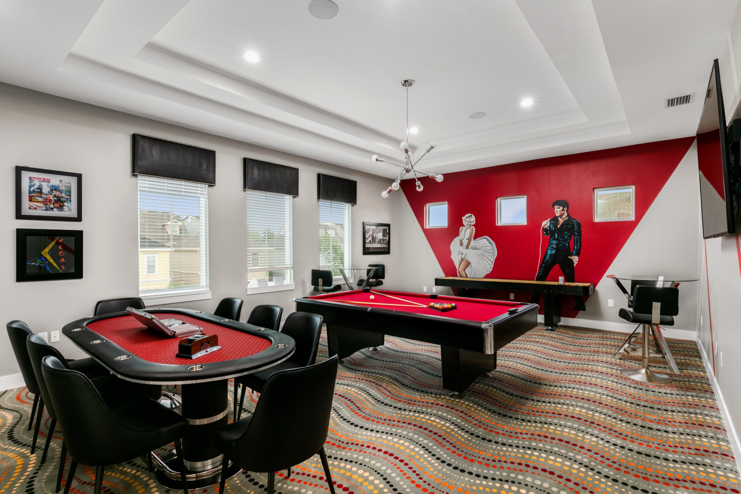 Vegas-themed game room with a poker table, pool table, and a red Elvis-and-Marilyn mural wall