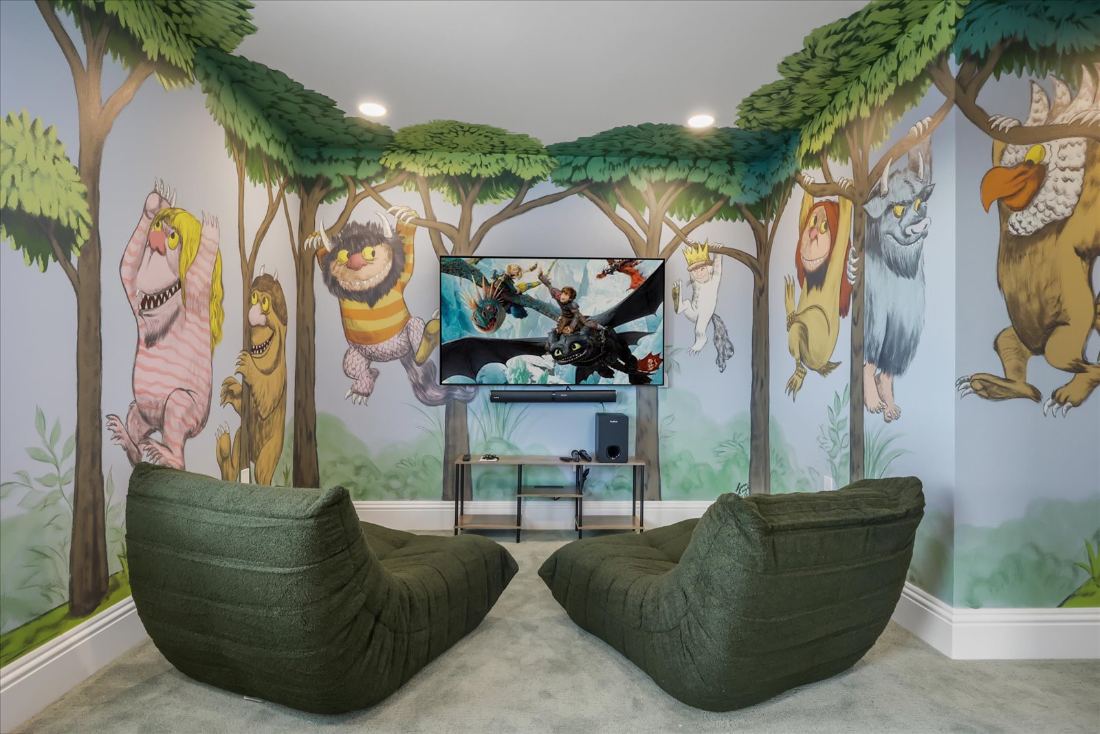 Themed children's suite with a hand-painted jungle mural and hanging chairs