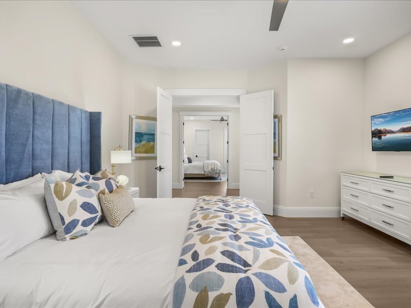 The second guest suite from another angle, with its tufted headboard and floral bedding