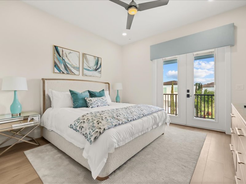 Guest suite with teal accents and doors to a balcony