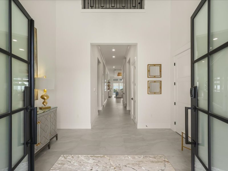 Entry gallery hall with glass doors framing the courtyard