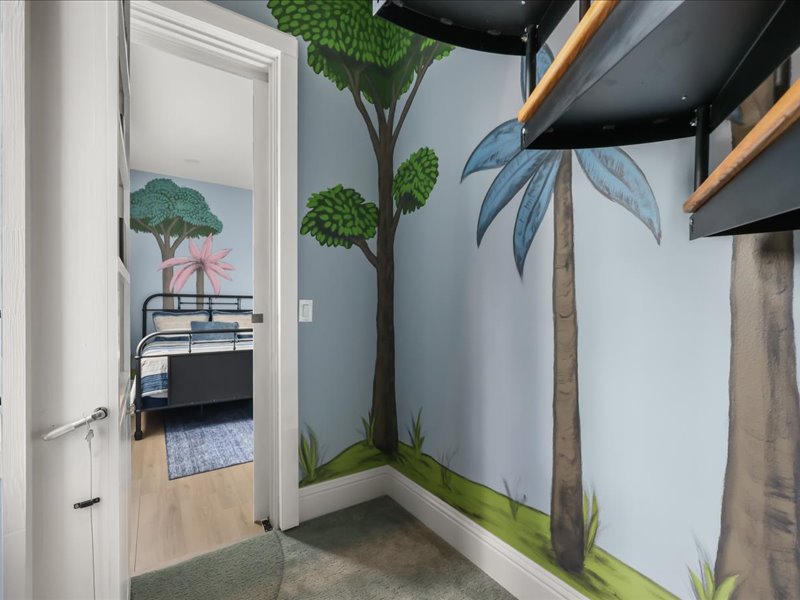 Bunk suite tucked into a painted tree-and-sky mural