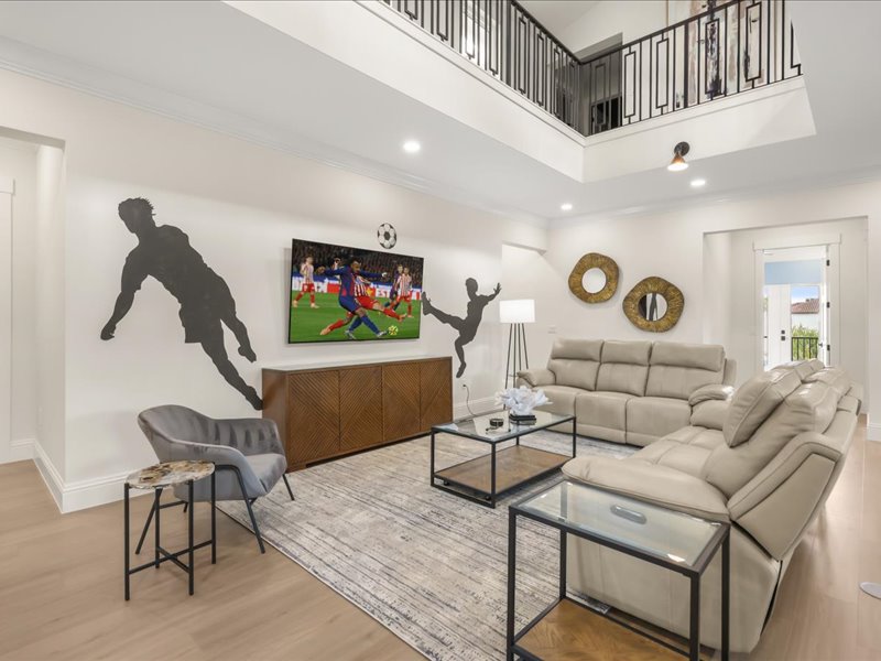 The two-story lounge from another angle, in soft grays open to the main floor