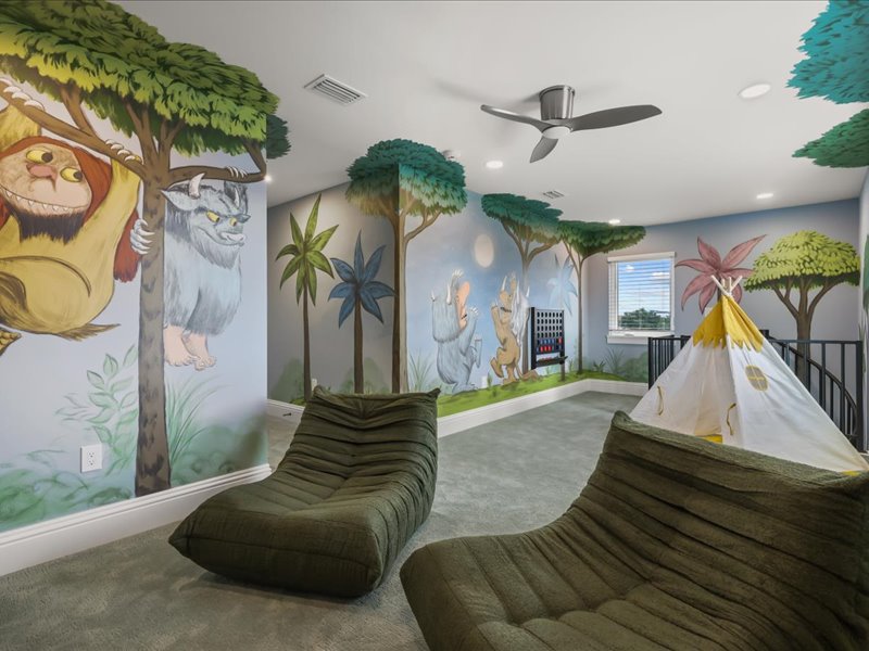 Playroom corner with a teepee under the tree mural