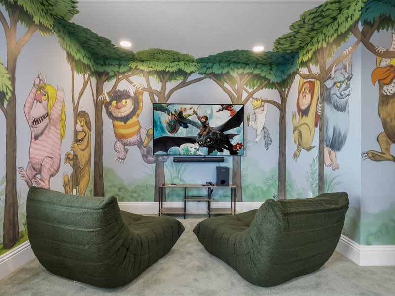 Themed playroom with a storybook wall mural and bean-bag seating
