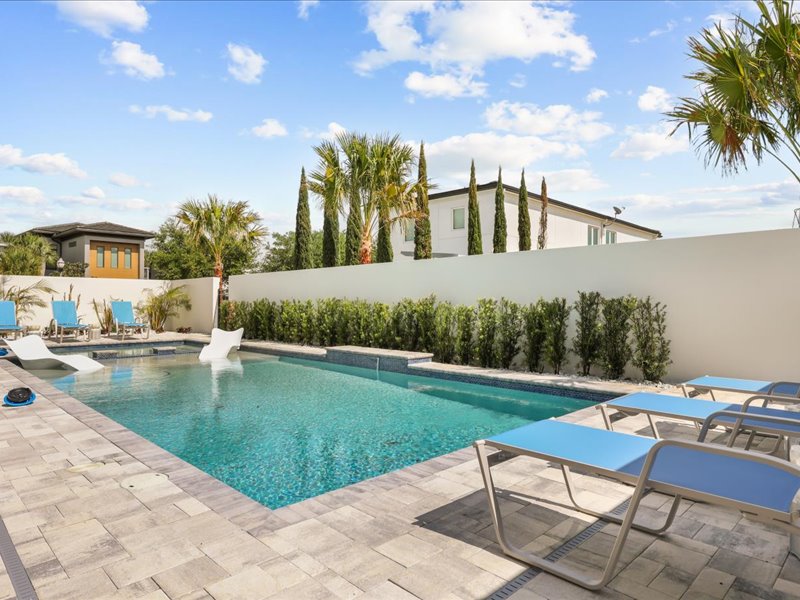 The resort pool and raised spa set in travertine against the fairway