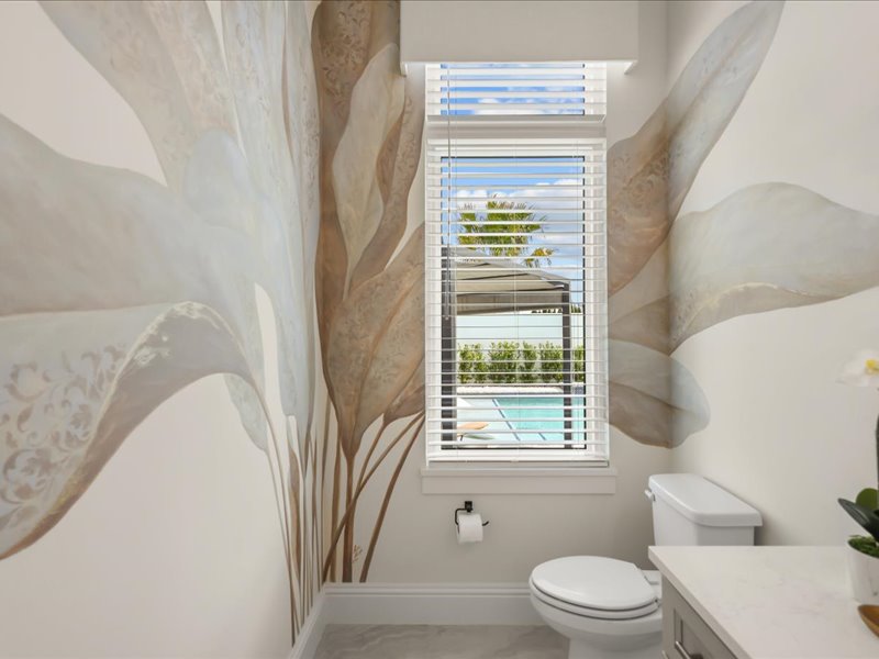 Powder room with botanical wallpaper off the main floor