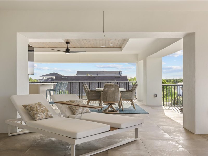 Third-story terrace with daybeds and lounge seating