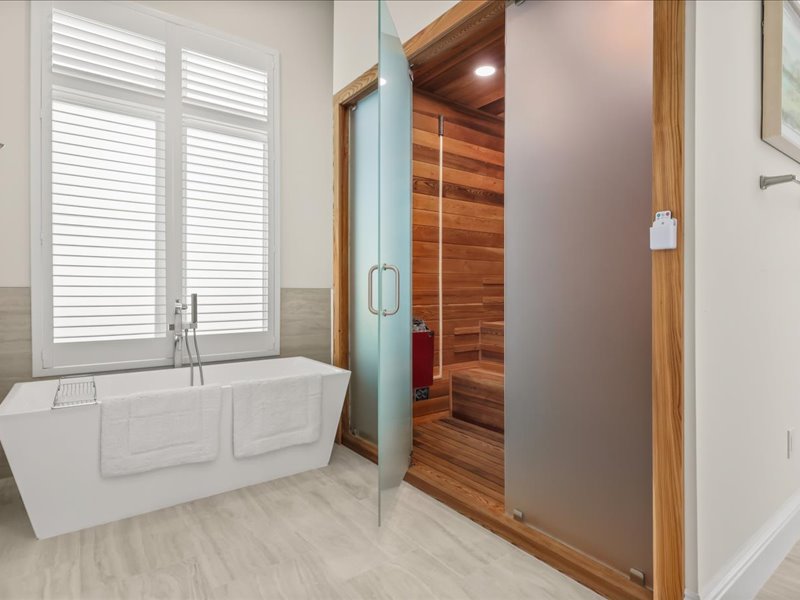 Bath with a soaking tub beside a cedar sauna
